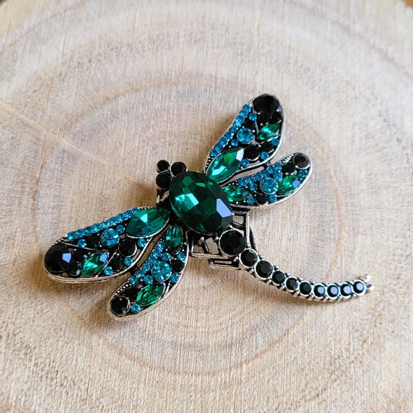 broche dorée Demoiselle, un bijou moderne d’une libellule ornée de strass verts