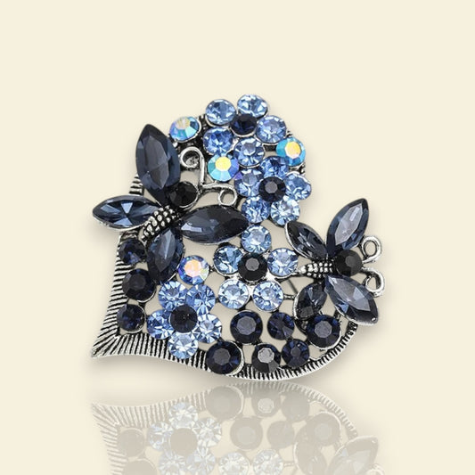 broche dorée Sentimientos, une broche d’un cœur de papillons et de strass bleus pour femme chic