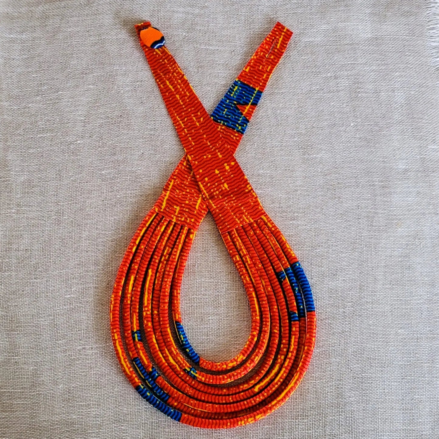 collier en tissu Aïcha, un bijou africain traditionnel en pagne rouge vermillon et bleu