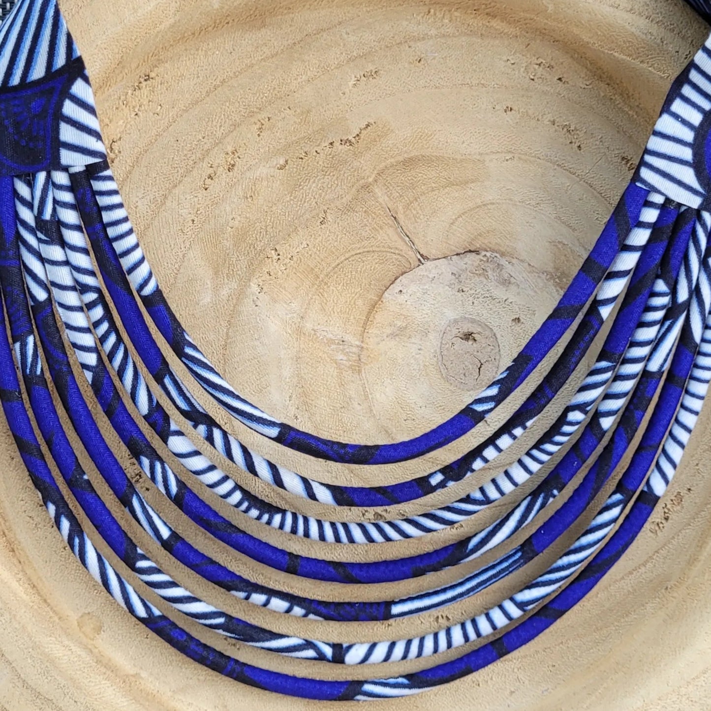 collier en tissu Aïssatou, un collier coloré composé de sept rangs de cordons recouverts de tissu wax