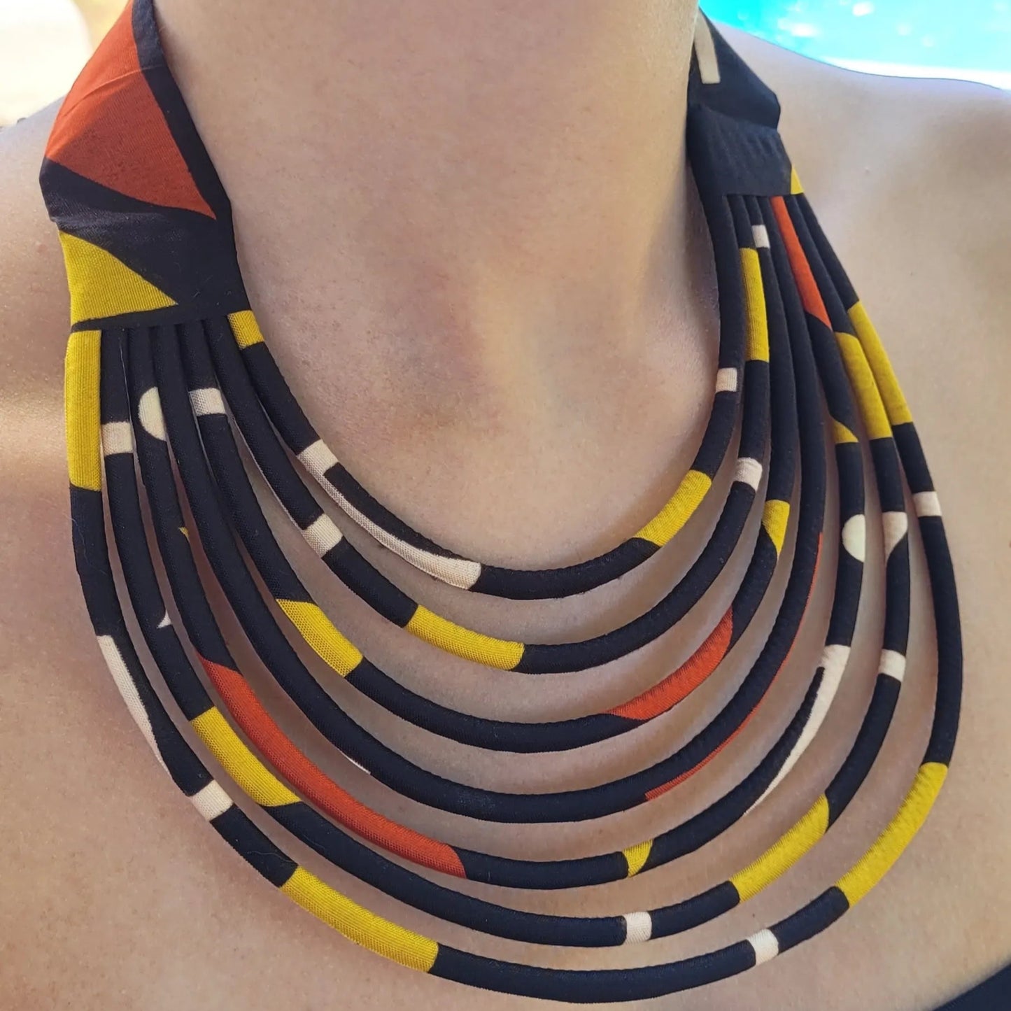 collier en tissu Diena, un collier ethnique chic composé de sept rangss de cordons recouverts de tissu wax