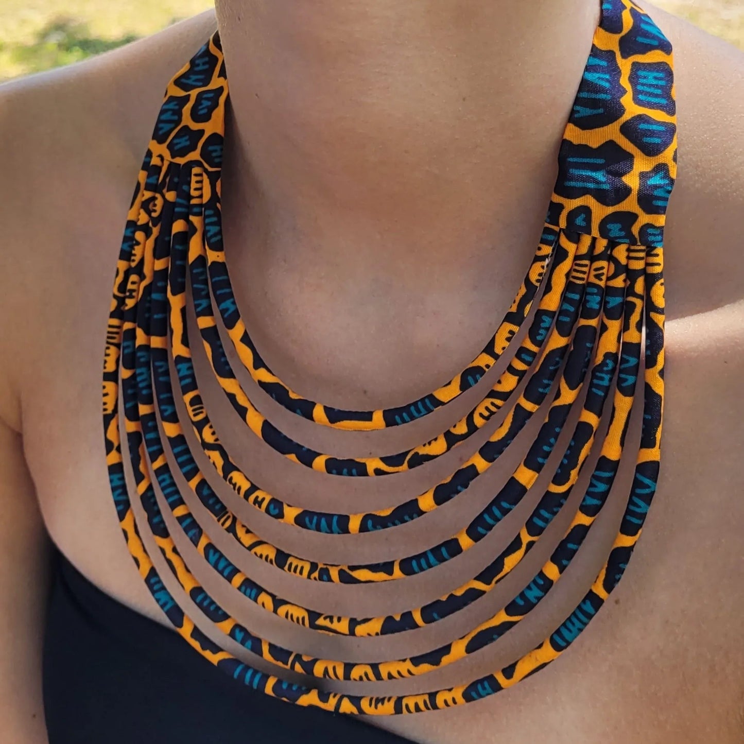 collier en tissu Nabintou, un collier ethnique chic en pagne orange, noir et bleu canard