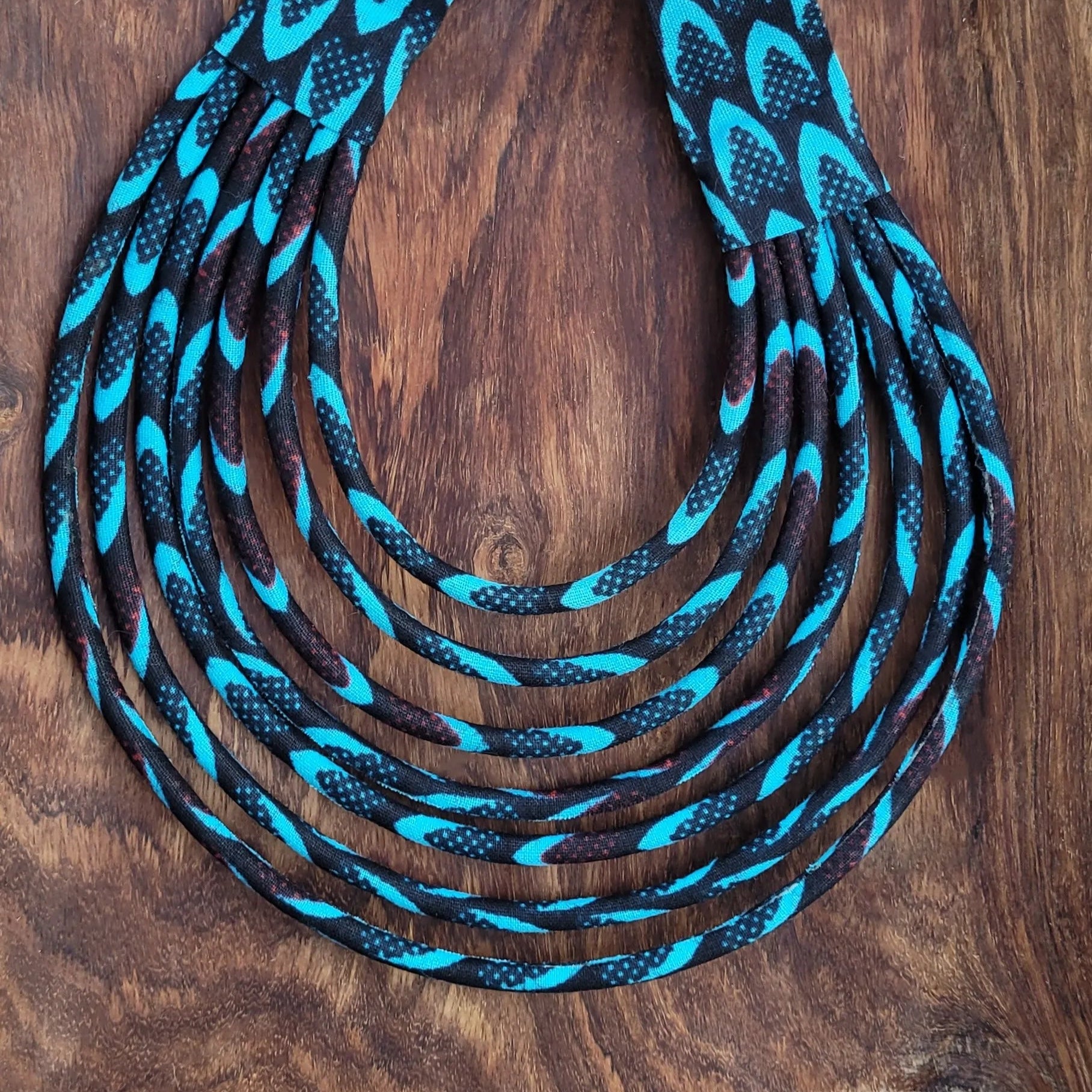 collier en tissu Awa, un collier coloré composé de sept rangs de cordons recouverts de tissu wax